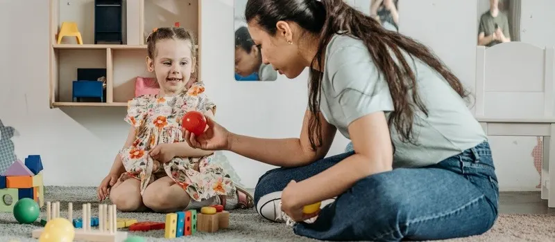 How To Start A Daycare | Preschool Business Guide 2026 6 A Preschool Attendant Playing With Children With Objects