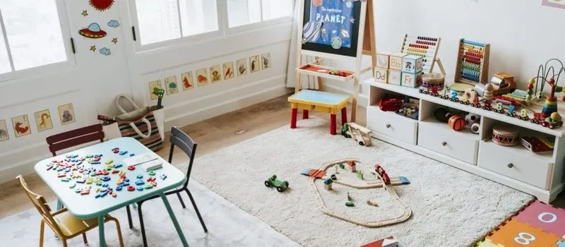 What Furniture Do You Need To Furnish A Daycare Center? | Startup Checklist 2 Kids Play Area In Daycare Center With Chair Table Rug And Toys