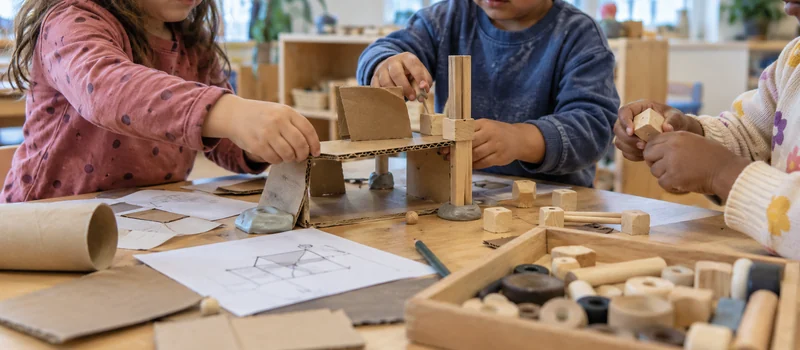 Makerspace Design: How To Create A Creative Learning Space In Preschool 4 Preschool Children Collaborating On A Cardboard And Loose-Parts Construction At A Low Activity Table