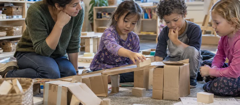 What Is A Makerspace? Understanding Making In Preschool 5 Preschool Children Testing A Cardboard Bridge During A Makerspace Activity